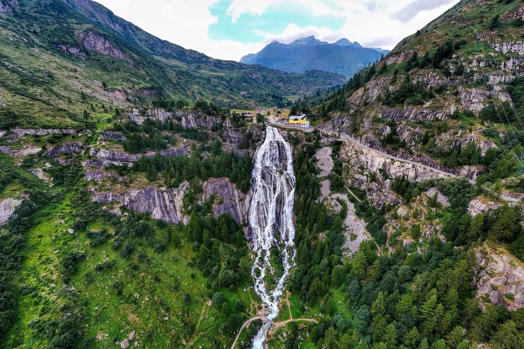 The Toce Waterfall in Val Formazza in full flow, plunging down a green alpine valley