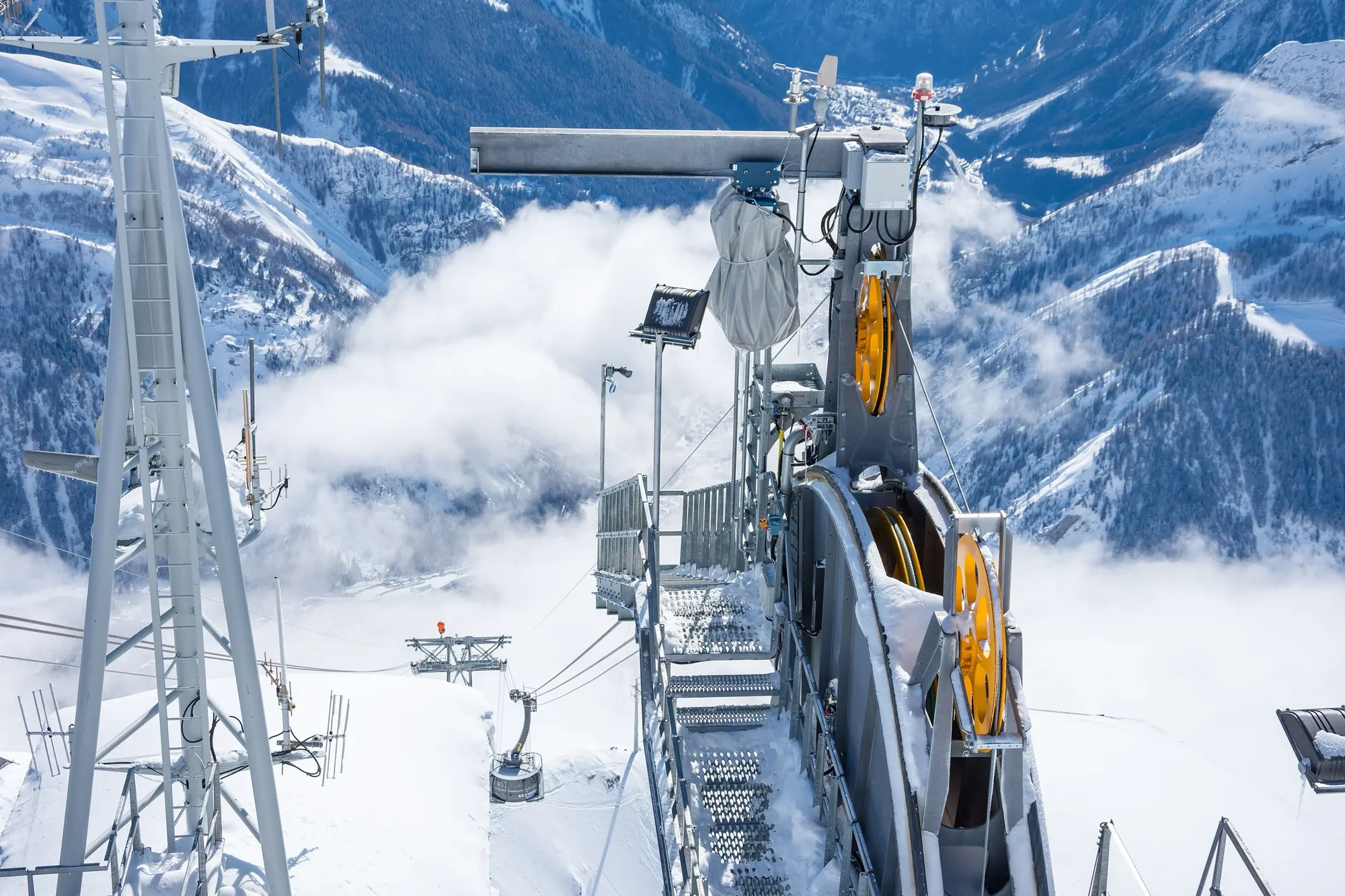 The Skyway Monte Bianco cable car arriving at Punta Helbronner above a sea of clouds