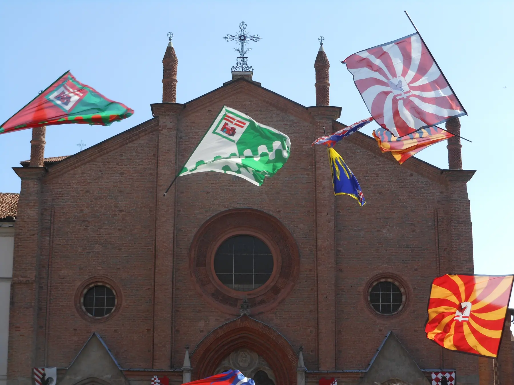 Flag throwers (sbandieratori) performing in front of the Collegiata di San Secondo during the Palio di Asti parade and race day, Asti